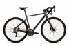 A gravel bicycle with a dark metallic blue-gray frame, black drop handlebars, black saddle, and black wheels, shown from a side profile on a white background.