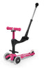 A pink and black children's kick scooter with a handlebar attachment, featuring three wheels with clear plastic guards and pink grips, shown on a white background.